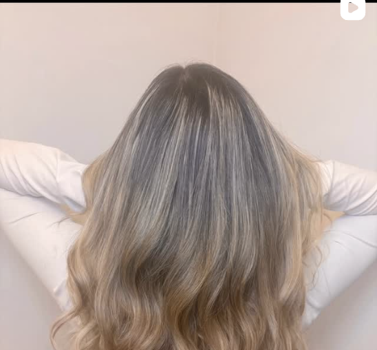 Full, natural-looking wavy nano hair extensions on a Bond Babes client